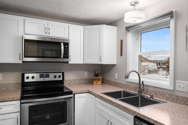 kitchen featuring white cabinets, appliances with stainless steel finishes, and sink