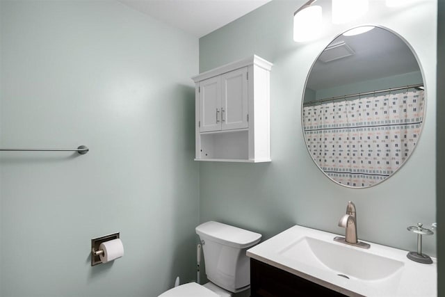 bathroom featuring toilet and vanity