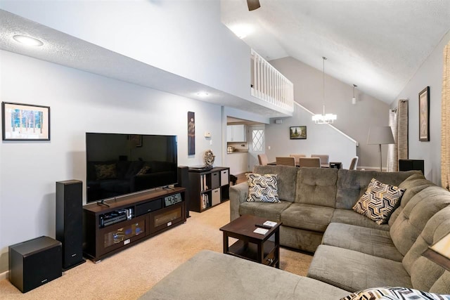 living room with lofted ceiling, a textured ceiling, a chandelier, and light carpet