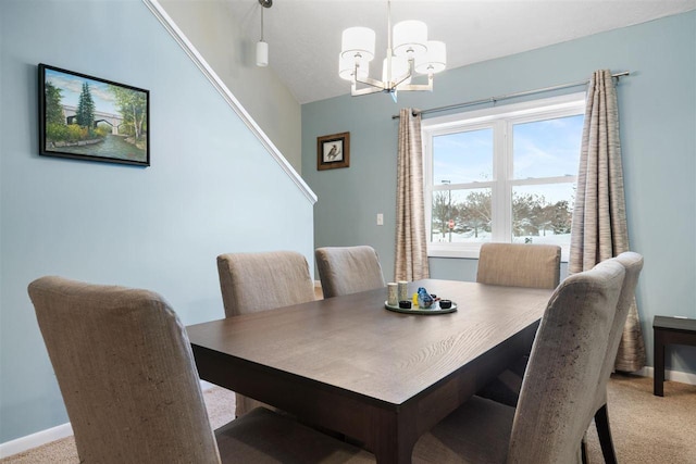 dining area with a notable chandelier and light carpet