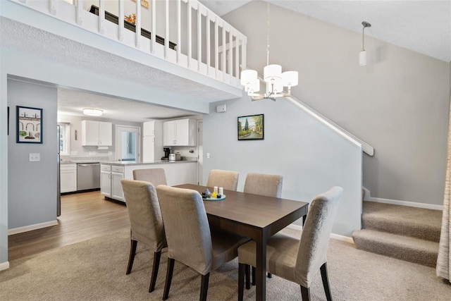 carpeted dining space featuring a high ceiling and a notable chandelier