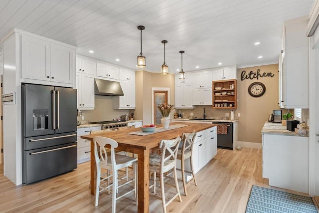 kitchen with white cabinets, black dishwasher, high quality fridge, light hardwood / wood-style flooring, and hanging light fixtures