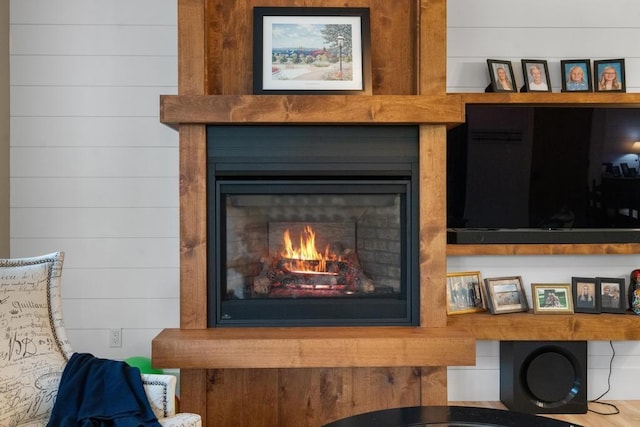 details with a fireplace and wooden walls