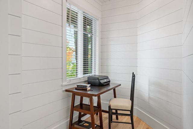 office space with hardwood / wood-style floors and wooden walls