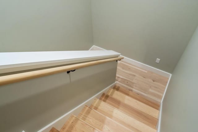 stairway featuring wood-type flooring