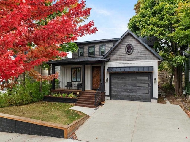 view of front of home with a garage and a porch