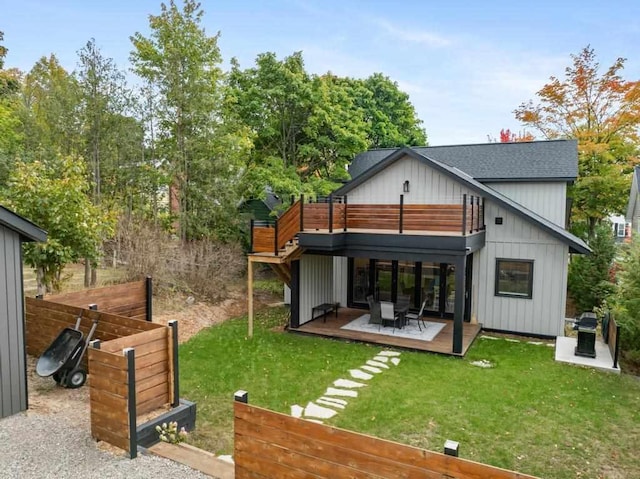 rear view of house featuring a yard and a wooden deck