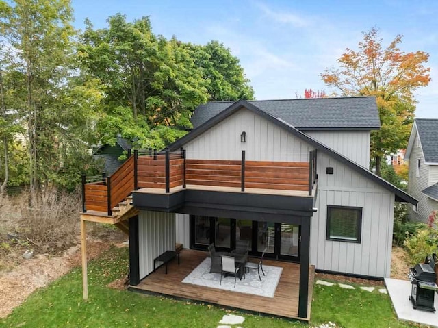 back of property with a lawn and a wooden deck