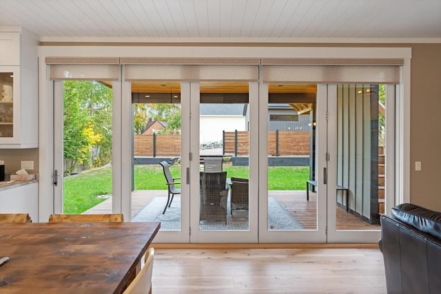 doorway to outside featuring light wood-type flooring, french doors, and wooden ceiling