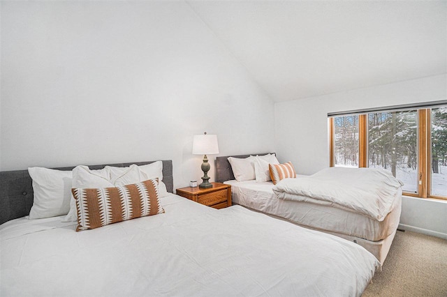 bedroom with vaulted ceiling and carpet