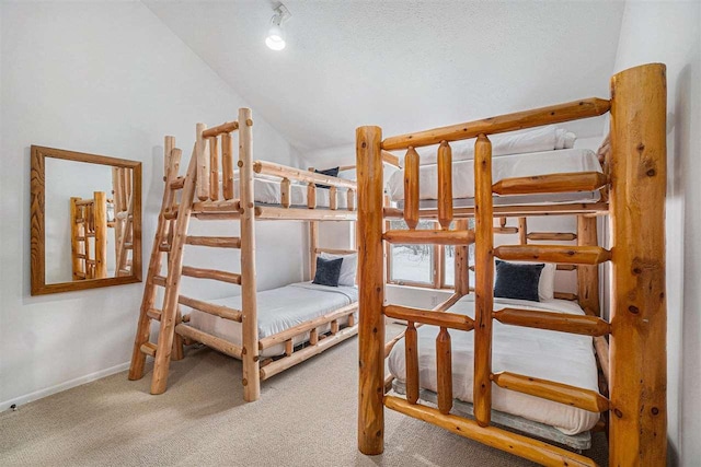 carpeted bedroom with lofted ceiling