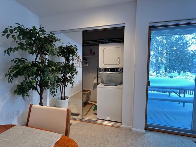 dining room with stacked washer / dryer and carpet floors