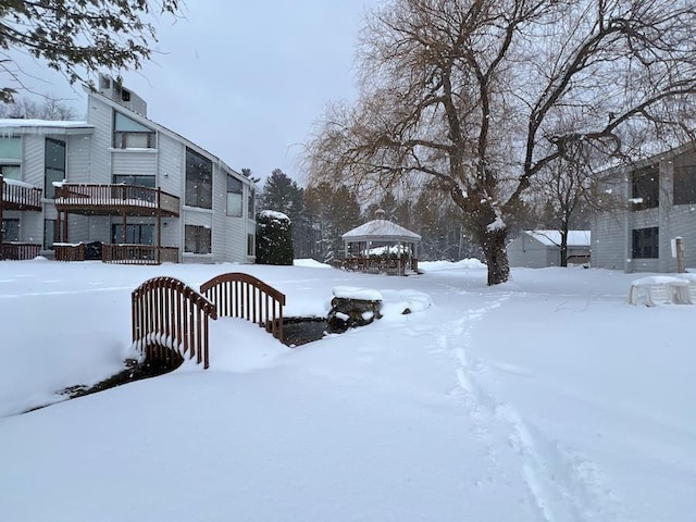 yard covered in snow with a gazebo