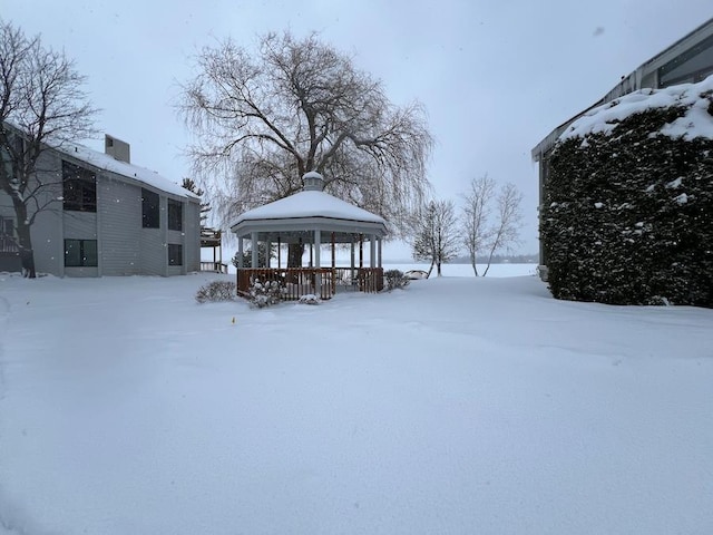 snowy yard with a gazebo