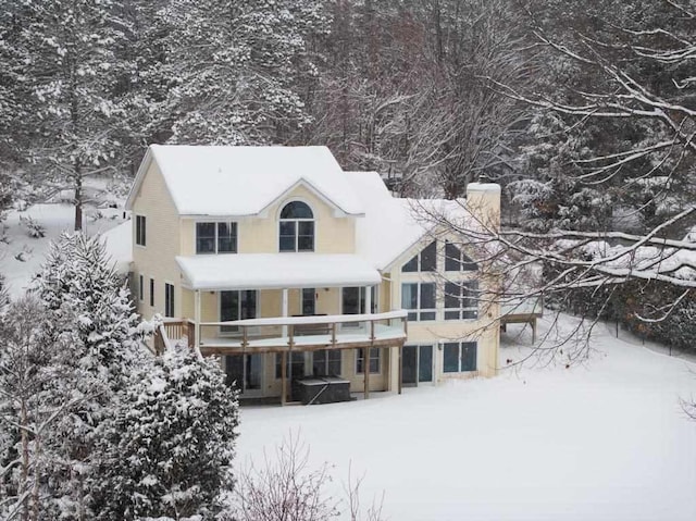 view of snow covered back of property