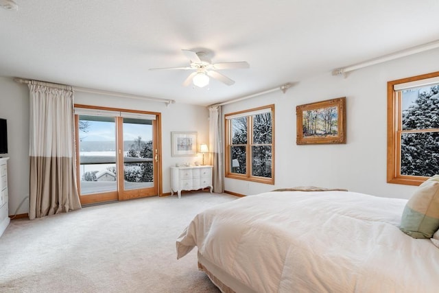 carpeted bedroom featuring ceiling fan and access to exterior