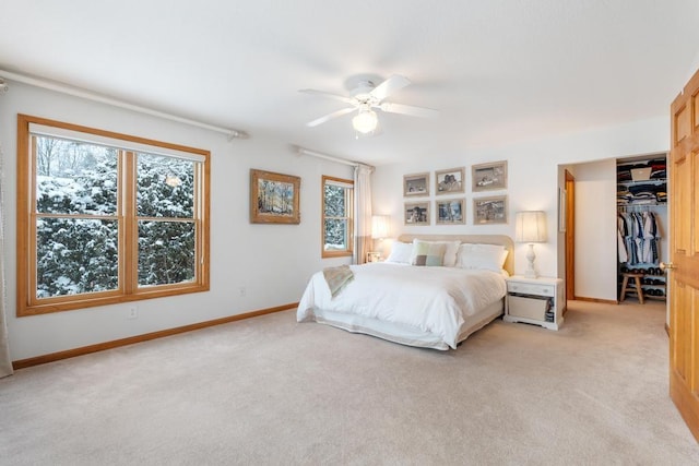 bedroom featuring ceiling fan, a closet, and light carpet