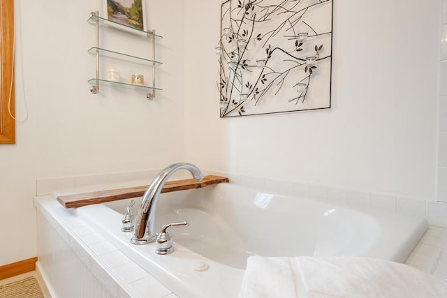 bathroom featuring tiled tub