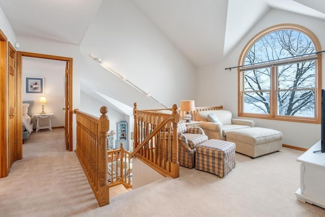 sitting room featuring light colored carpet and lofted ceiling