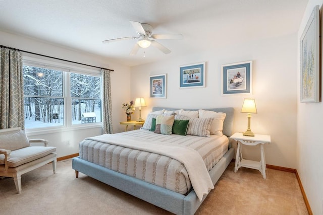 bedroom with ceiling fan and light carpet