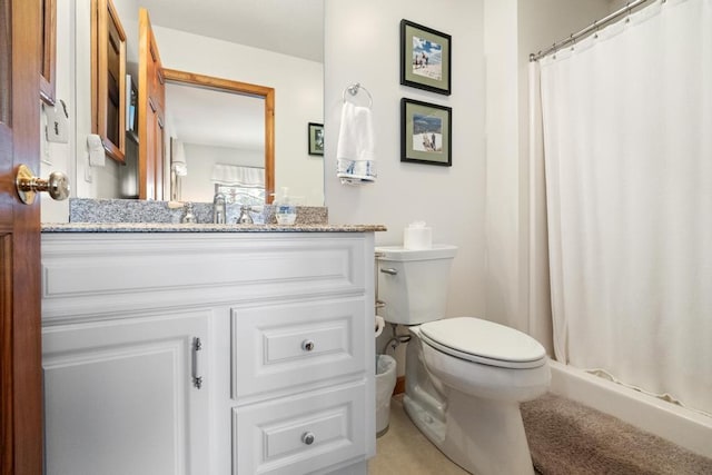 bathroom featuring toilet, vanity, and curtained shower