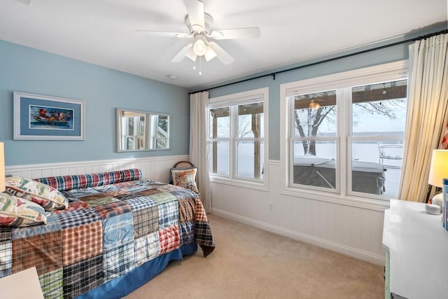 bedroom with ceiling fan and light colored carpet