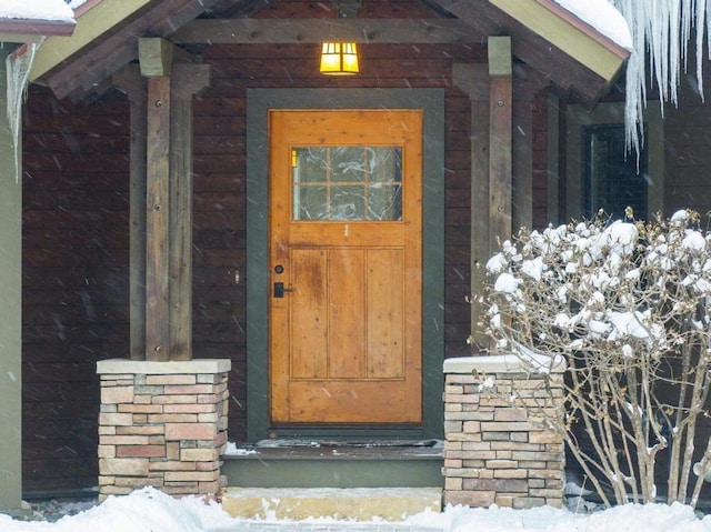 view of snow covered property entrance