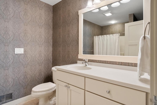 bathroom with toilet and vanity