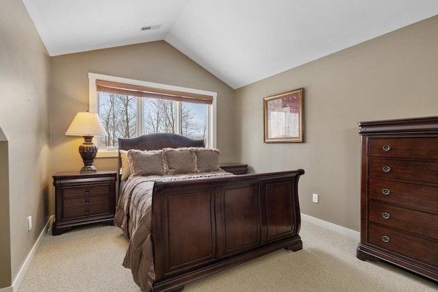 bedroom with lofted ceiling and light colored carpet