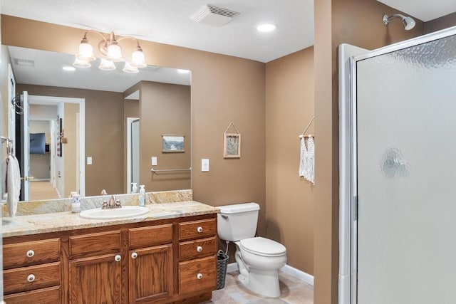 bathroom with toilet, vanity, tile patterned floors, and a shower with door