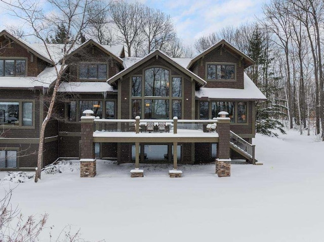 view of snow covered rear of property