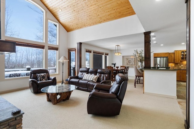 living room with light carpet, wood ceiling, and high vaulted ceiling