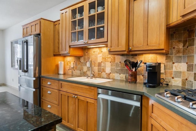 kitchen featuring sink, stainless steel appliances, and tasteful backsplash