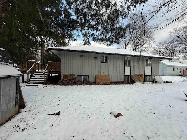 view of snow covered rear of property