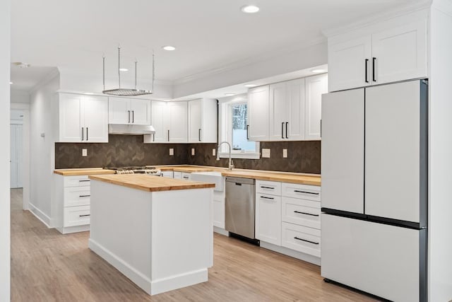 kitchen with white fridge, wood counters, white cabinetry, dishwasher, and light hardwood / wood-style flooring