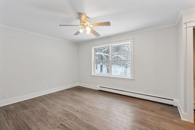 spare room featuring ceiling fan, wood-type flooring, a baseboard heating unit, and crown molding