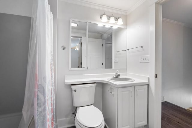 bathroom featuring toilet, hardwood / wood-style floors, ornamental molding, vanity, and curtained shower