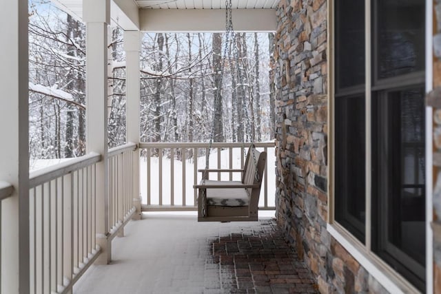 view of snow covered back of property