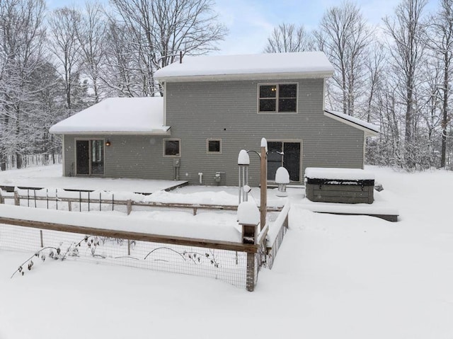 view of snow covered back of property