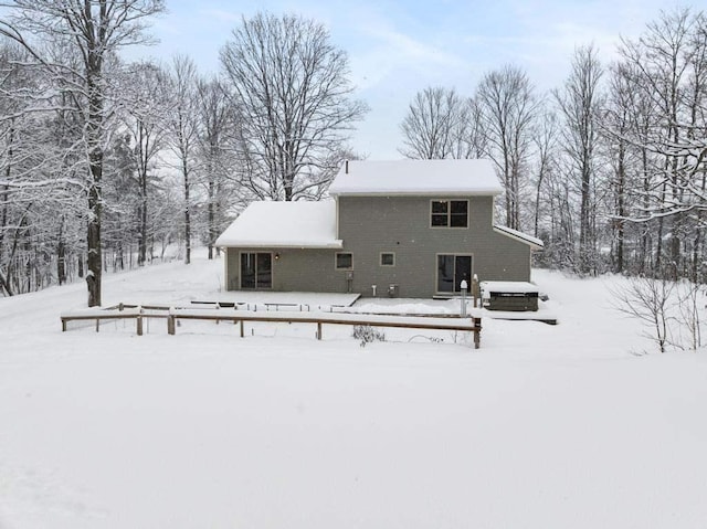 view of snow covered back of property