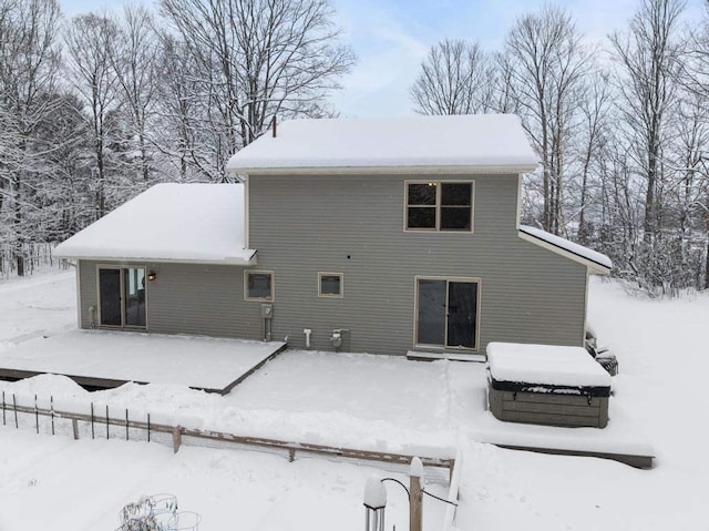 view of snow covered rear of property