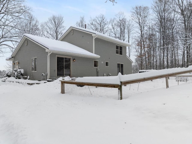 view of snow covered rear of property