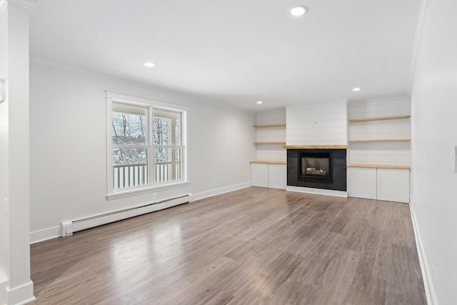 unfurnished living room featuring light wood-type flooring, a fireplace, crown molding, and a baseboard radiator