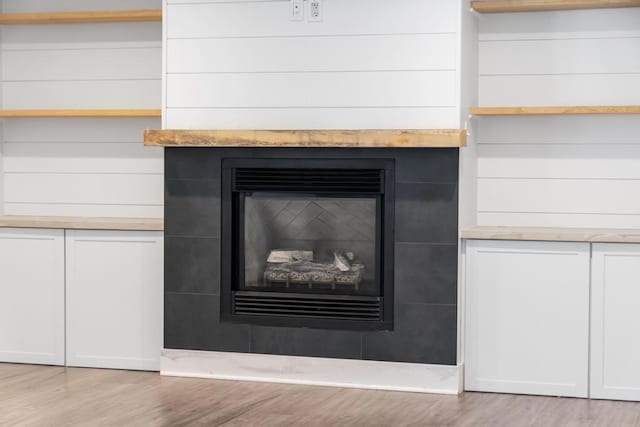 interior details with hardwood / wood-style floors and a fireplace