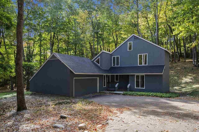 front facade with a garage and a porch