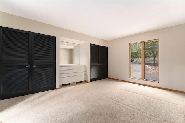 unfurnished bedroom featuring light carpet