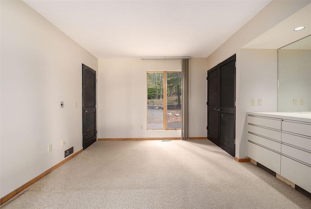 unfurnished bedroom with light carpet