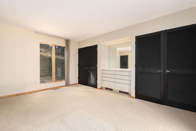 unfurnished bedroom featuring light carpet