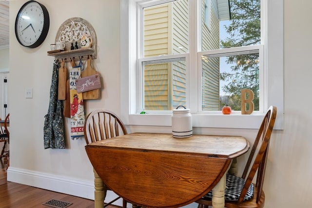 dining area featuring dark hardwood / wood-style flooring and a healthy amount of sunlight