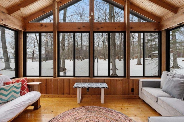 sunroom / solarium with wooden ceiling, a wealth of natural light, and vaulted ceiling with beams